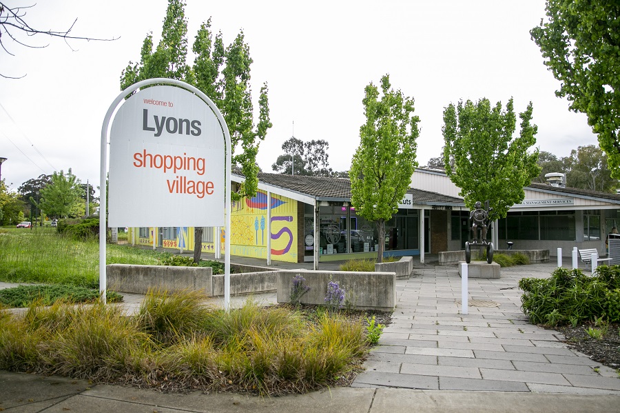 The exterior of Lyons shops. A sign says 'Lyons Shopping Village'.